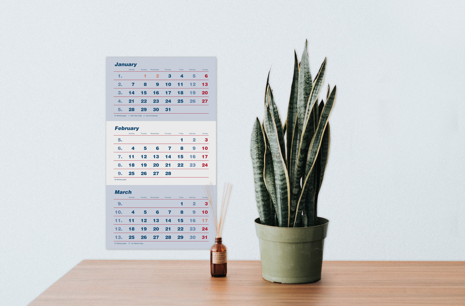Three months calendar in English with stacked months. It was set in red and blue in Helvetica and includes the number of working days, the calendar week and English holidays